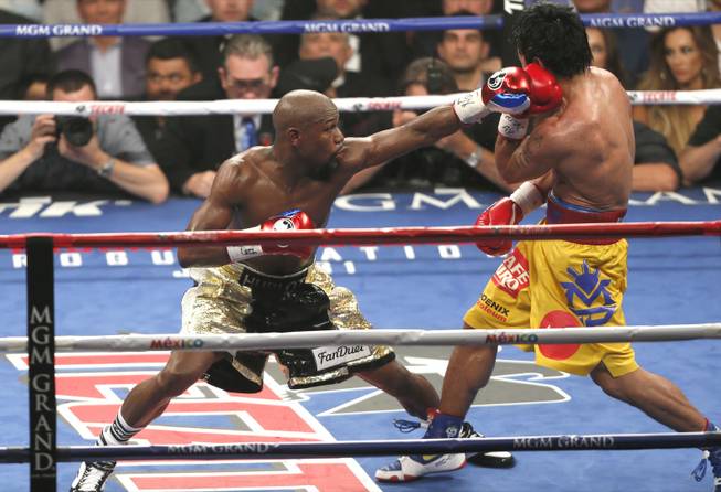 Floyd Mayweather Jr. lands a punch on Manny Pacquiao on Saturday, May 2, 2015.