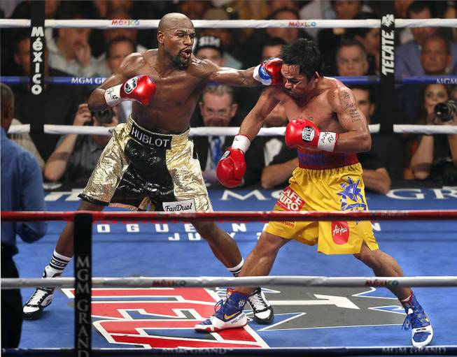 Floyd Mayweather connects to the chin of Manny Pacquiao late in their fight at the MGM Grand Garden Arena.
