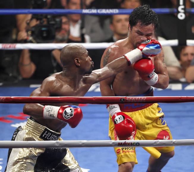 Floyd Mayweather connects to the chin of Manny Pacquiao late in their fight at the MGM Grand Garden Arena on Saturday, May 2, 2015