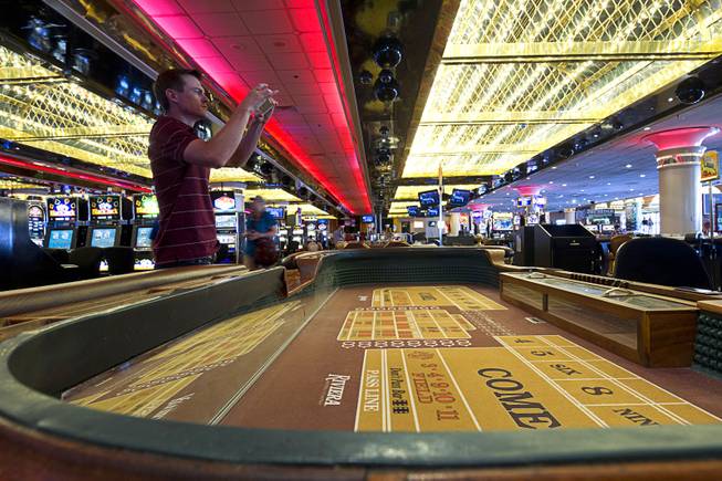 10:10 a.m. - Todd Smith of Las Vegas takes a photo on the casino floor in the Riviera Monday, May 4, 2015. The 60-year-old Riviera, which was the Las Vegas Strip's first high-rise property, will be imploded to make way for a $2.3 billion convention center business district facility. 