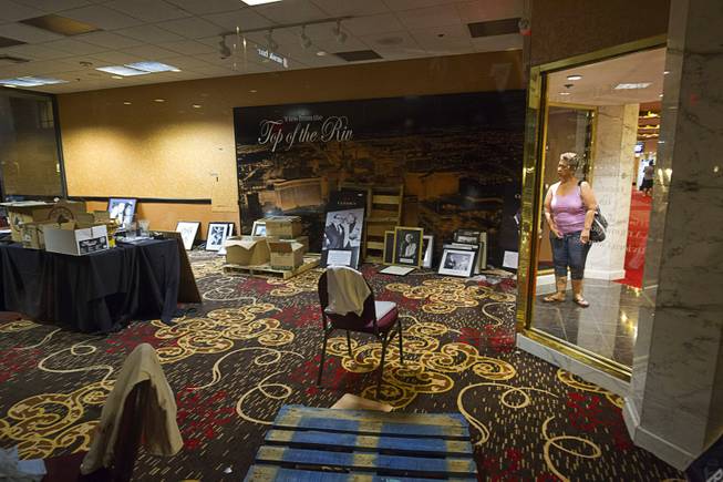 1:14 a.m. - A woman looks office filled with historic photos at the Riviera Monday, May 4, 2015.