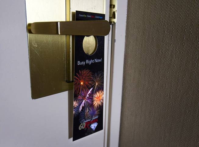9:17 a.m. - A door hanger is shown in a room at the Riviera Monday, May 4, 2015.