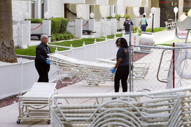 9:32 a.m. - Workers take away pool lounge chairs at the Riviera Monday, May 4, 2015.