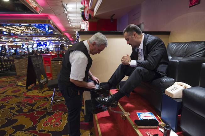 10:26 a.m. - Fernando Formoso of White Plains, N.Y., gets a shoe shine from Glenn Comeau at the Riviera on Monday, May 4, 2015.  