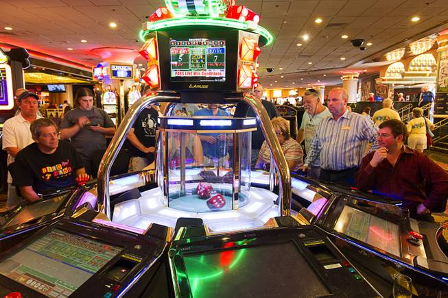 12:07 p.m. - Gamblers, including Mike Palm, right, vice president of operations at the D Las Vegas, play a electronic craps machine at the Riviera Monday, May 4, 2015. Riviera slot director Chuck Palermo, second right, allowed the game to continue until a seven was rolled. STEVE MARCUS