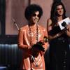 In this Feb. 8, 2015, photo, Prince presents the award for album of the year at the 57th annual Grammy Awards in Los Angeles.