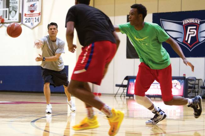 Basketball coach Mike Peck passes a ball to Troy Brown Jr. during practice for the Las Vegas Prospects, an Amateur Athletic Union team, at the Henderson International School gym. 