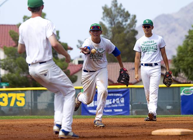 Drake Maningo, center, tosses to Frankie Fitzgerald during Green Valley High School baseball practice in Henderson Monday, May 11, 2015. Blake Inouye is at right. On Thursday, the team begins play in the four-team Division I state tournament, looking for the program's first state championship since 2003. 