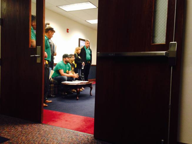 SolarCity employees sit in the offices of Senate Republican leadership on Monday. More than 70 Solar employees stormed the Legislature on Monday May 11, 2015 to ask lawmakers to lift a cap on a controversial solar policy called net metering.
