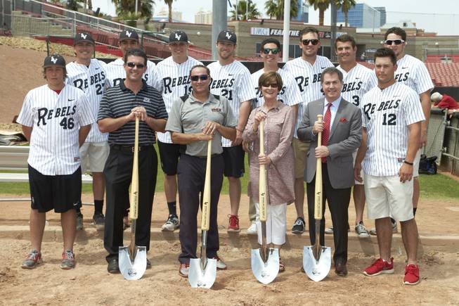 Ten current UNLV baseball players stand around, from left, donor Anthony Marnell III, coach Tim Chambers, Athletic Director Tina Kunzer-Murphy and President Len Jessup at the ceremonial groundbreaking for the Anthony and Lyndy Marnell III Baseball Clubhouse on Monday, May 11, 2015, at Earl E. Wilson Stadium.