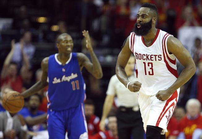 Houston Rockets guard James Harden, right, reacts to scoring as Los Angeles Clippers guard Jamal Crawford brings the ball up the court during the third quarter of Game 7 of the NBA Western Conference semifinals at the Toyota Center in Houston on Sunday, May 17, 2015.