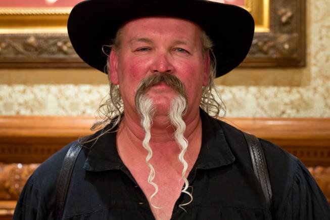 James Watson poses for a portrait after winning Longest Mustache at the Whiskerino Contest, a facial hair competition during the Las Vegas Elk's Helldorado Days, Sat May 16, 2015.