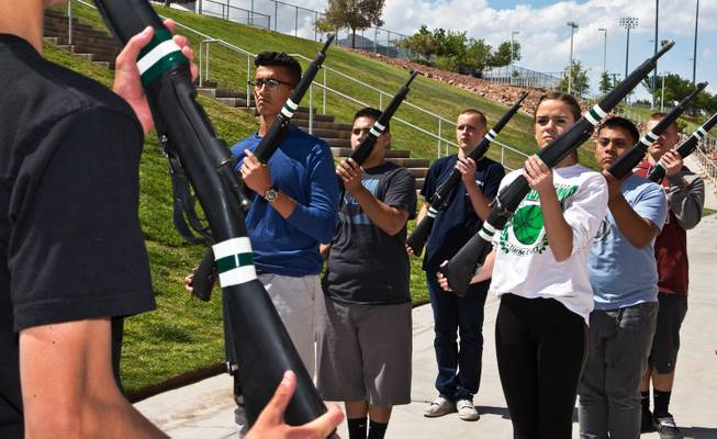 Palo Verde ROTC cadet Karim Hussein (left) practices rifle drills with other members at the high school on May 19, 2015. He saved his dad from drowning in a freak accident in March and was awarded the ROTC"s highest honor May 13, 2015.