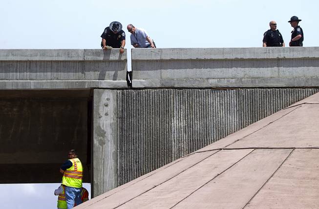 Nevada Highway Patrol troopers and Nevada Department of Transportation workers inspect an expansion joint on the 95 south to I-15 south ramp after an earthquake Friday, May 22, 2015.