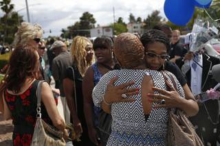 Rita Washington, facing at right, daughter of B.B. King, embraces mourners waiting in line during a public viewing of the blues legend Friday, May 22, 2015, in Las Vegas. King died last week at 89.