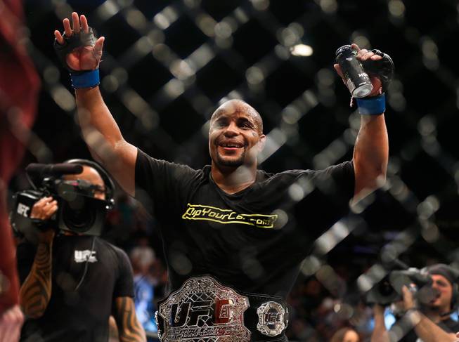 UFC light heavyweight champion Daniel Cormier celebrates his win over Anthony Johnson ending their UFC 187 fight at the MGM Grand Garden Arena on Friday, May 22, 2015.