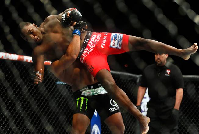 UFC light heavyweight contender Anthony Johnson is lifted up and slammed to the canvas by opponent Daniel Cormier during their UFC 187 fight at the MGM Grand Garden Arena on Friday, May 22, 2015.