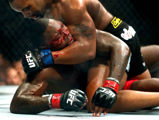 UFC light heavyweight contender Anthony Johnson is bloodied and dominated on the canvas by opponent Daniel Cormier during their UFC 187 fight at the MGM Grand Garden Arena on Friday, May 22, 2015.