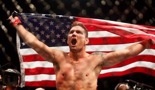 UFC middleweight champion Chris Weidman celebrates his win over contender Vitor Belfort during their UFC 187 fight at the MGM Grand Garden Arena on Friday, May 22, 2015.