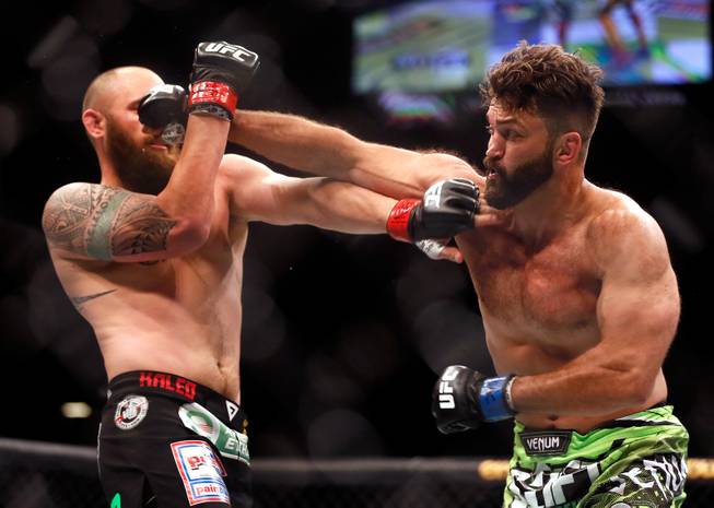 UFC heavyweight contender Travis Browne takes a shot to the face from contender Andre Arlovski during their UFC 187 fight at the MGM Grand Garden Arena on Friday, May 22, 2015.