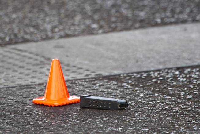 An evidence cone is shown next to an ammunition clip as Metro Police investigate a shooting at Arville Street and Flamingo Road Sunday, May 24, 2015. Four people were reported shot at a Terrible Herbst gas station and car wash in what is believed to be an attempted robbery of victims in a BMW outside of the gas station.