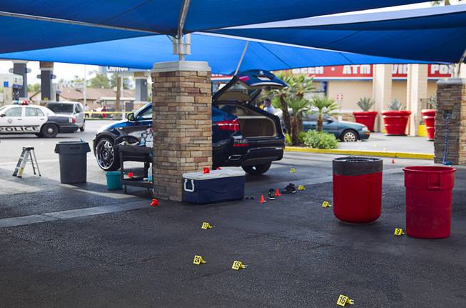 A  BMW SUV is shown as Metro Police investigate a shooting at Arville Street and Flamingo Road Sunday, May 24, 2015. Four people were reported shot at a Terrible Herbst gas station and car wash in what is believed to be an attempted robbery of victims in a BMW outside of the gas station.
