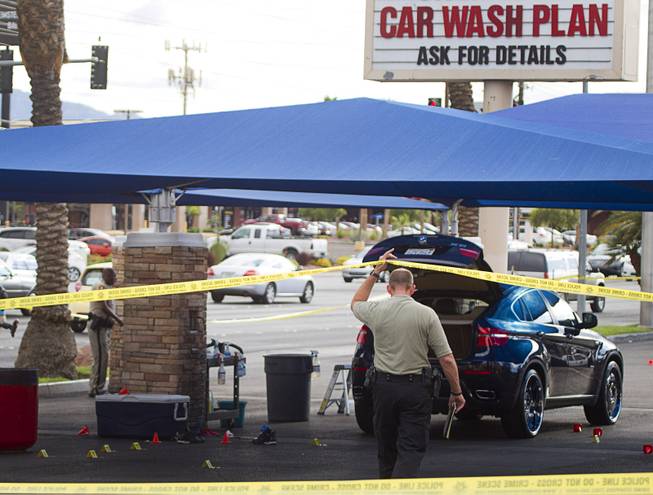 Metro Police investigate a shooting at Arville Street and Flamingo Road Sunday, May 24, 2015. Four people were reported shot at a Terrible Herbst gas station and car wash in what is believed to be an attempted robbery of victims in a BMW outside of the gas station.