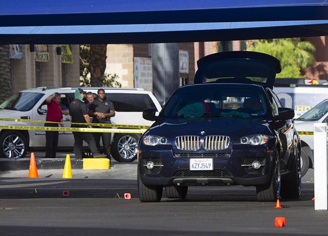 A BMW SUV is shown after a shooting at Arville Street and Flamingo Road Sunday, May 24, 2015. Four people were reported shot at a Terrible Herbst gas station and car wash in what is believed to be an attempted robbery of victims in a BMW outside of the gas station.