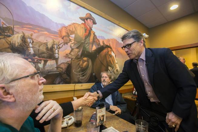 Former Texas Gov. Rick Perry greets voters during a meet-and-greet event at Pizza Ranch in Sioux Center, Iowa, on May 18, 2015. Although politicking in diners and pizza places is hardly new in the leadoff caucus state, Perry has been notably active in some of Iowa’s more out-of-the-way places, which get less frequent traffic from presidential hopefuls.