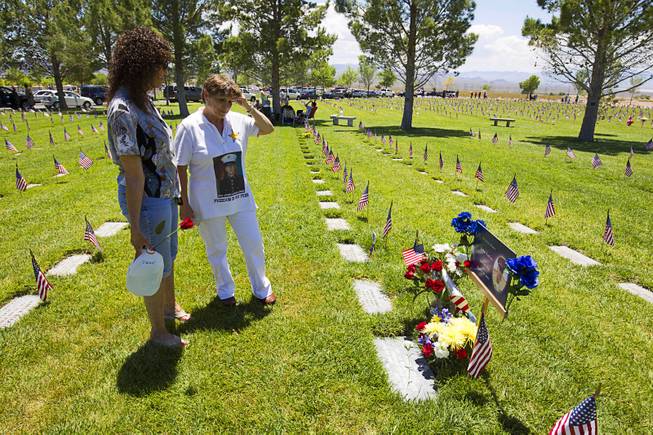 Martha Collins, left, talks with Helena Lukac by her son's gravesite on Memorial Day at the Southern Nevada Veterans Memorial Cemetery in Boulder City Monday, May 24, 2015. John Lukac, 19, a Durango High School graduate, died during Operation Iraqi Freedom in 2004.