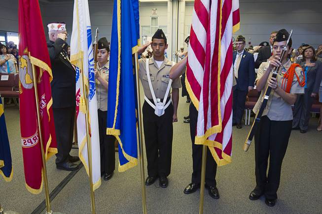 Members of the Chaparral High School NJROTC Honor Guard post the colors during a Memorial Day Ceremony at the Southern Nevada Veterans Memorial Cemetery in Boulder City Monday, May 24, 2015.