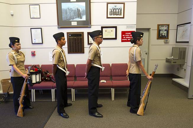 Members of the Chaparral High School NJROTC Honor Guard wait to retire the colors during a Memorial Day Ceremony at the Southern Nevada Veterans Memorial Cemetery in Boulder City Monday, May 24, 2015.