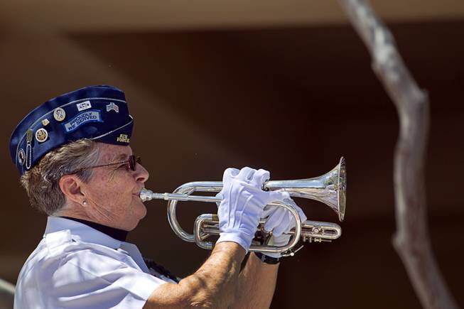 Carolyn Whaley plays taps during a Memorial Day Ceremony at the Southern Nevada Veterans Memorial Cemetery in Boulder City Monday, May 24, 2015.