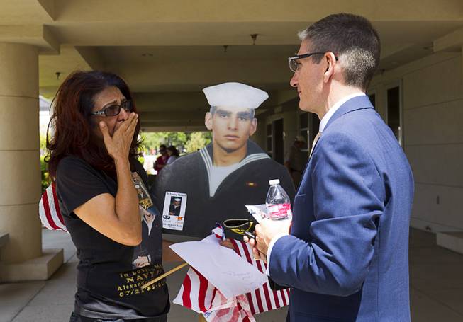 Farideh Ghane holds a cutout of her son as she listens to Congressman Joe Heck (R-Nev) following a Memorial Day Ceremony at the Southern Nevada Veterans Memorial Cemetery in Boulder City Monday, May 24, 2015. Ghanes' son, Navy SEAL Alexander Ghane Jr., 22, of Las Vegas, died during a training exercise in 2008.
