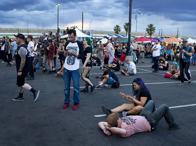 Fans relax before the evening's rain during the 17th annual Punk Rock Bowling & Music Festival in downtown Las Vegas Sunday, May 24, 2015.