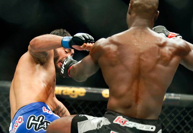 UFC middleweight contender Rafael Natal takes a punch to the face from contender Uriah Hall during their UFC 187 fight at the MGM Grand Garden Arena on Friday, May 22, 2015.