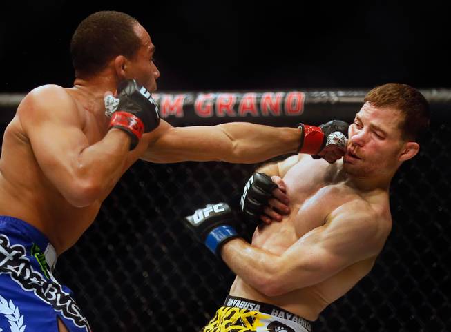 UFC flyweight contender John Dodson connects with a punch to the jaw of contender Zach Makovsky during their UFC 187 fight at the MGM Grand Garden Arena on Friday, May 22, 2015.