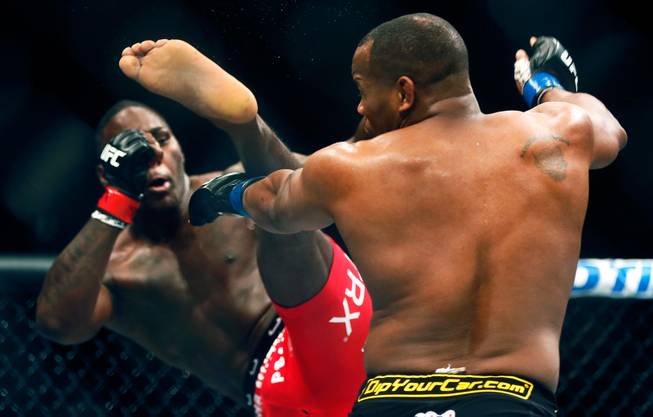 UFC light heavyweight contender Anthony Johnson connects with a kick to the chin of opponent Daniel Cormier during their UFC 187 fight at the MGM Grand Garden Arena on Friday, May 22, 2015.