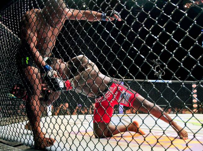 UFC light heavyweight contender Daniel Cormier is driven into the fence by opponent Anthony Johnson during their UFC 187 fight at the MGM Grand Garden Arena on Friday, May 22, 2015.