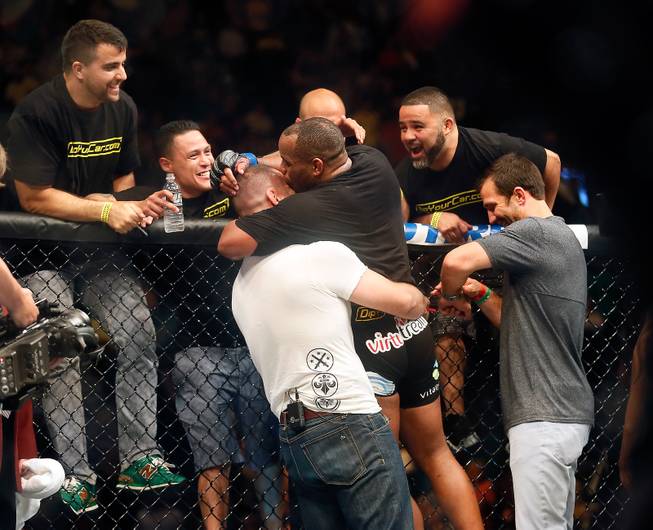 New UFC light heavyweight champion Daniel Cormier celebrates with his team after beating opponent Anthony Johnson during their UFC 187 fight at the MGM Grand Garden Arena on Friday, May 22, 2015.