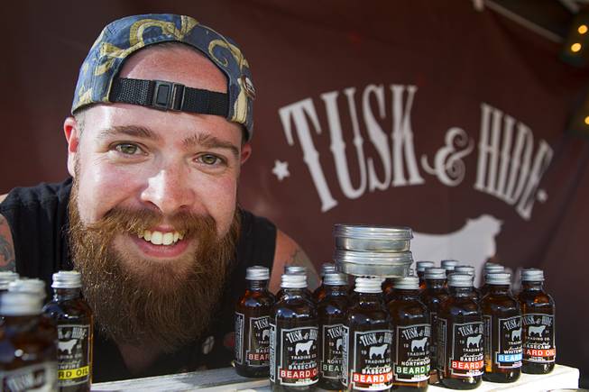 Dane Mentzer, the founder and CEO of Tusk & Hide Trading Co., poses at his booth in a vendor area of the Punk Rock Bowling & Music Festival in downtown Las Vegas Monday, May 25, 2015.
