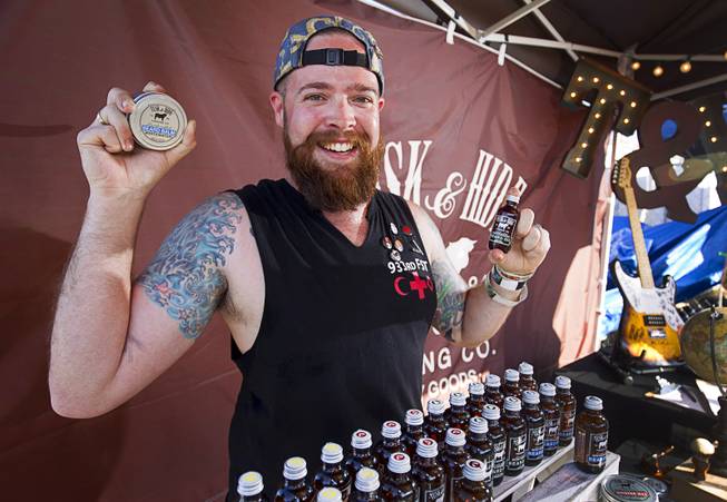 Dane Mentzer, the founder and CEO of Tusk & Hide Trading Co., poses at his booth in a vendor area of the Punk Rock Bowling & Music Festival in downtown Las Vegas Monday, May 25, 2015.