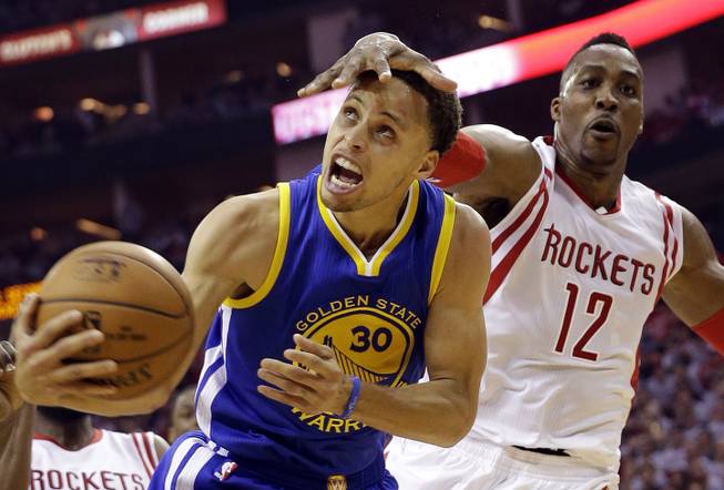 Houston Rockets center Dwight Howard fouls Golden State Warriors guard Stephen Curry during the first half in Game 3 of the NBA basketball Western Conference finals Saturday, May 23, 2015, in Houston. 