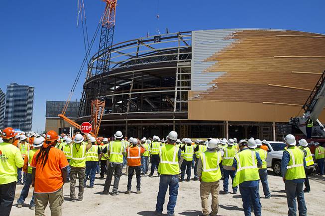 Workers watch as the final steel beam is lifted into place during a topping off ceremony for the Las Vegas Arena on Wednesday, May 27, 2015. Representatives from MGM Resorts International and AEG, contractors Hunt-Penta and elected officials were on hand to celebrate the installation of the arena's final steel beam. The $375 million arena is scheduled to open in Spring 2016.