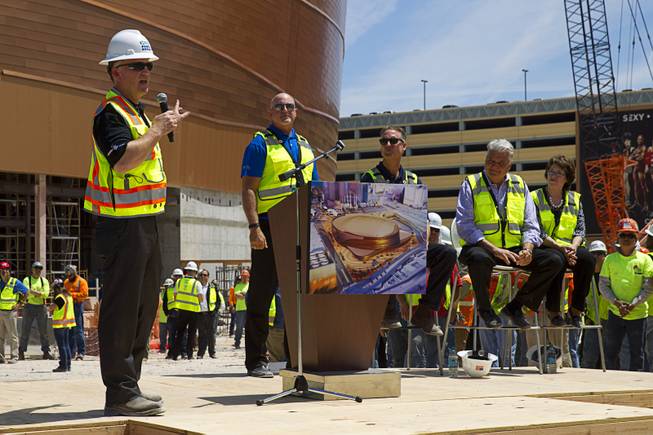 Monte Thurmond, left, project executive for Hunt-Penta Joint Venture, speaks during a topping off ceremony for the Las Vegas Arena Wednesday, May 27, 2015. Representatives from MGM Resorts International and AEG, contractors Hunt-Penta and elected officials were on hand to celebrate the installation of the arena's final steel beam. The $375 million arena is scheduled to open in Spring 2016.