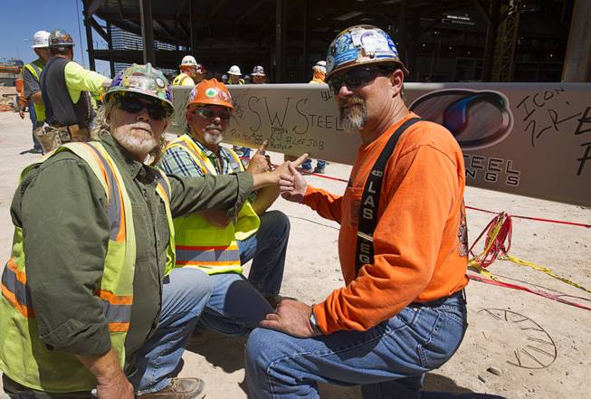 Rusty Moore, left, a superintendent with Southwest Steel, and ironworkers Dennis "Big D" Huston, center, and Kevin Jackson pose during a topping off ceremony for the Las Vegas Arena Wednesday, May 27, 2015. The workers will retire after the arena project is done, they said. The $375 million arena is scheduled to open in Spring 2016.