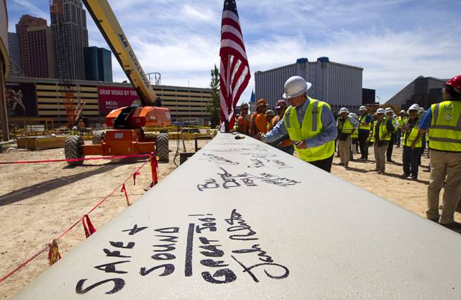 People sign the final steel beam during a topping off ceremony for the Las Vegas Arena Wednesday, May 27, 2015. Representatives from MGM Resorts International and AEG, contractors Hunt-Penta and elected officials were on hand to celebrate the installation of the arena's final steel beam. The $375 million arena is scheduled to open in Spring 2016.