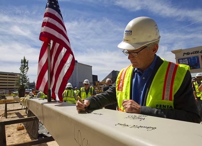 Jeff Ehret, president of Penta Building Group, signs the final steel beam during a topping-off ceremony for the Las Vegas Arena on Wednesday, May 27, 2015, in Las Vegas. Representatives from MGM Resorts International and AEG, contractors Hunt-Penta and elected officials were on hand to celebrate the installation of the arena's final steel beam. The $375 million arena is scheduled to open in Spring 2016.