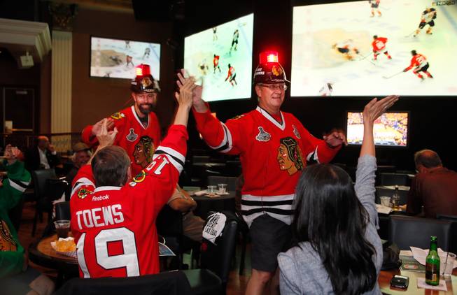 Blackhawk fans celebrate another score as Bill Foley, the businessman trying to bring a NHL team to Las Vegas, meets with fans at Sunset Station on Wednesday, May 27, 2015.