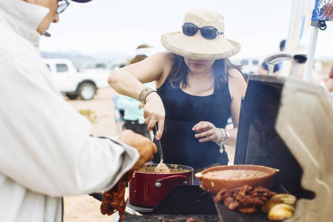 Irene Favela prepares food at Justin Favela's Family Fiesta at Michael Heizer's Double Negative located in the Moapa Valley on Mormon Mesa near Overton, Nevada on May 9, 2015.